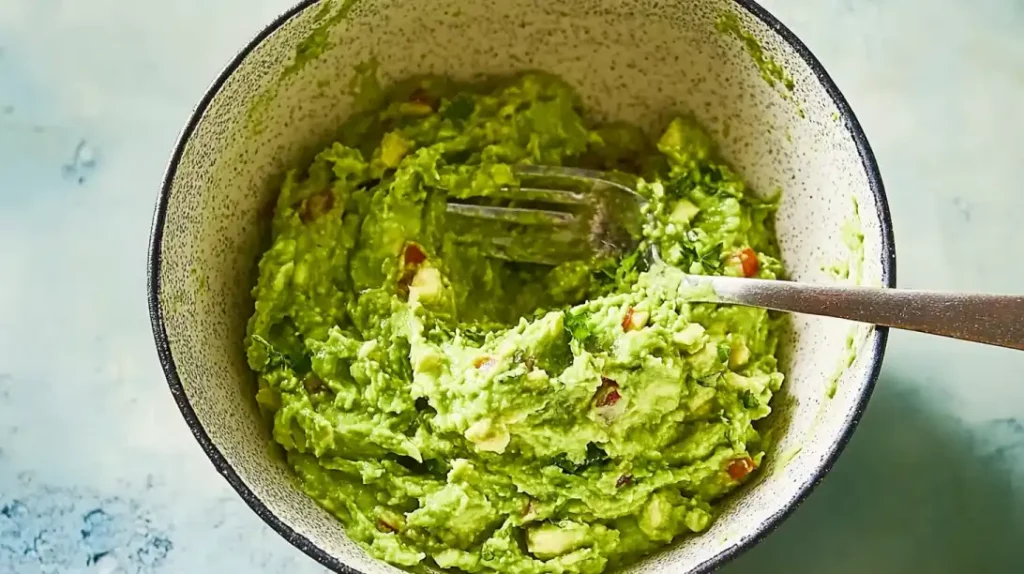 Creamy and flavorful homemade guacamole, mixed with a fork for the perfect texture.