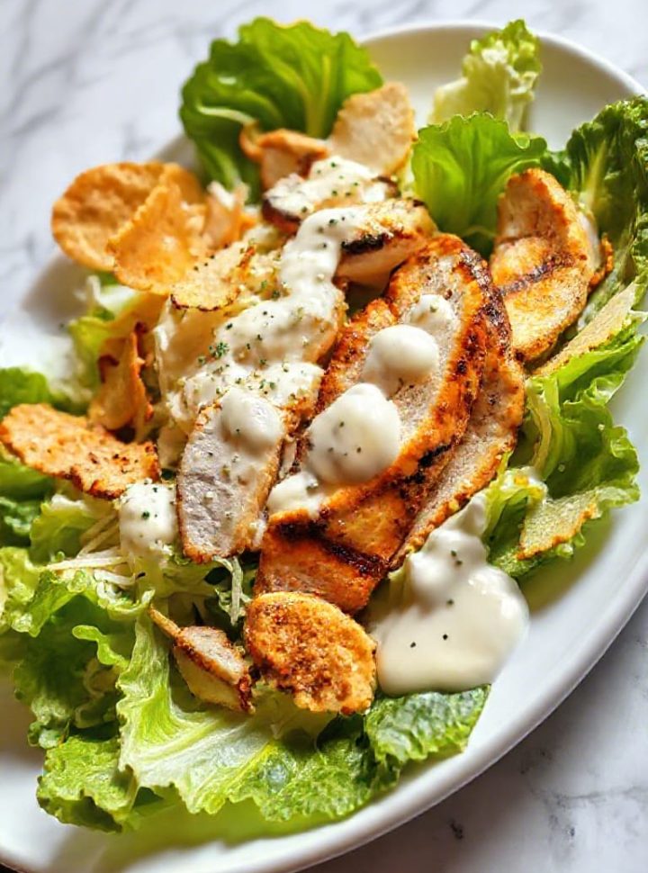 Low-carb Caesar salad with grilled chicken and Parmesan crisps.